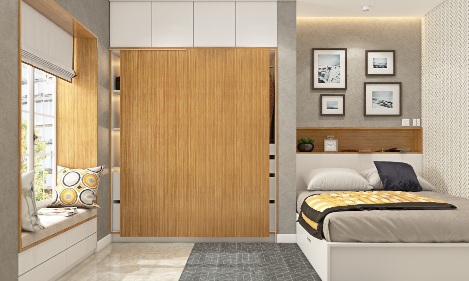 Sliding wardrobe doors in a light wood finish introduces natural vibes in the bedroom with loft storage