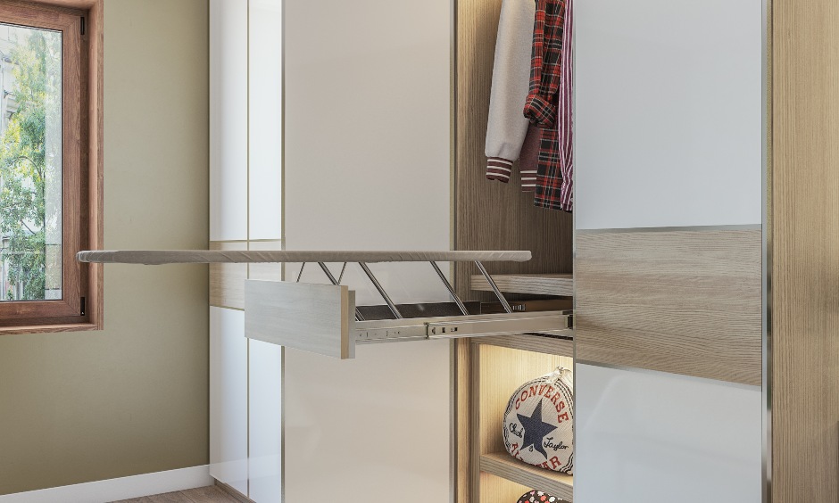 A white wardrobe design with an in-built iron board suitable for kids bedroom